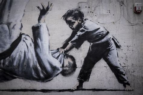 Photos: Graffiti, likely by Banksy, appears all over war-torn city in Ukraine | | fox23.com