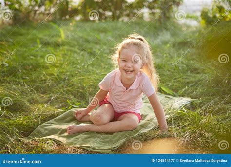 Little Girl Is Sitting On The Grass Stock Image Image Of Stem People