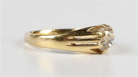 A Gold And Diamond Single Stone Ring Claw Set With A Cushion Cut