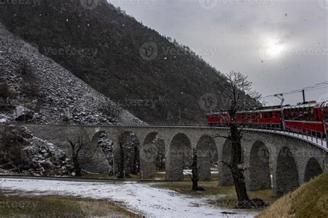 Red train in the snow in swiss alps 11968201 Stock Photo at Vecteezy