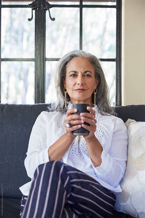 Portrait Of Mature Woman With Grey Hair Relaxing And Drinking Tea In