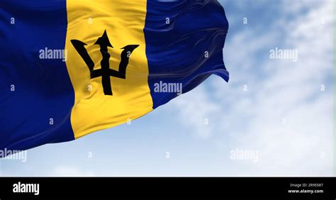 Barbados National Flag Waving On A Clear Day Blue And Yellow Flag With