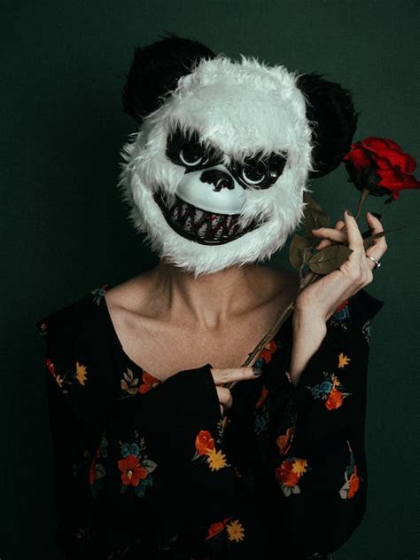 Woman in a Scary Mask with a Red Rose in her Hand · Free Stock Photo