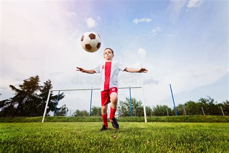 Boy Playing with Football Ball on Playing Field. Stock Image - Image of ...