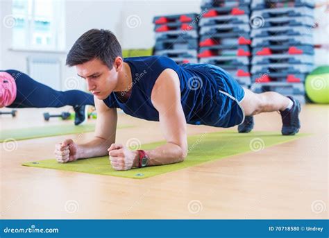 Fitness Training Athletic Sporty Man Doing Plank Exercise In Gym Or