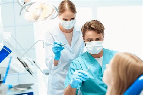 Premium Photo A Dentist And A Nurse Are Treating The Patient