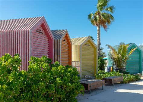 Colorful Beach Huts Near Green Trees Under Blue SkyFree Stock Photo