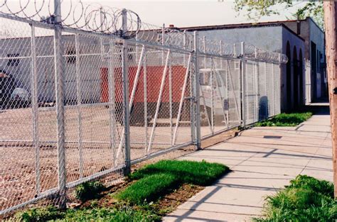 Double 8ft High Cantalever Gates With Bard Wire And Razor Ribbo