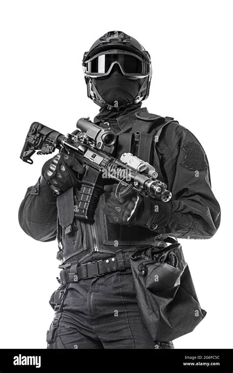 Studio shot of swat operator with assault rifle. Tactical helmet gloves ...