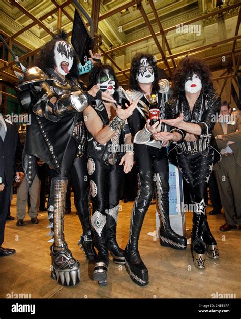 Members Of The Rock Group Kiss Pose For Photos On The Floor Of The New