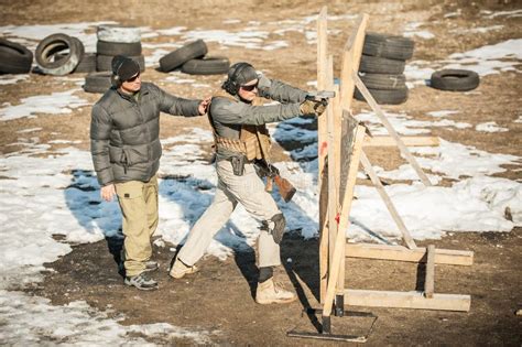 Instructor Teaches Student Tactical Gun Shooting Behind Cover Or