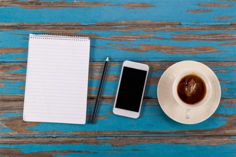 Premium Photo Notepad Pencil Smartphone And Cup Of Tea