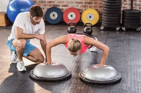 Premium Photo Male Trainer Assisting Woman Doing Push Ups