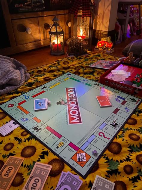 a monopoly board game on a sunflower blanket