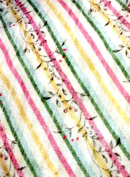 A Close Up View Of A Colorful Striped Shirt With Cats And Flowers On