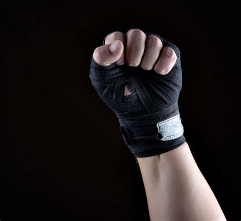 Premium Photo Cropped Hand Of Boxer Wearing Bandage Against Black