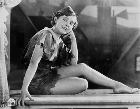 An Old Photo Of A Woman Sitting On A Ledge