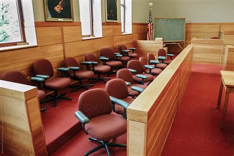 "Jury Box In Courtroom With Nobody" by Stocksy Contributor "Raymond Forbes LLC" - Stocksy