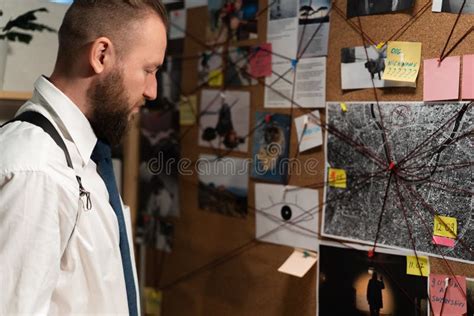 Detective Looking at Evidence Board with Crime Scenes, Photos of ...