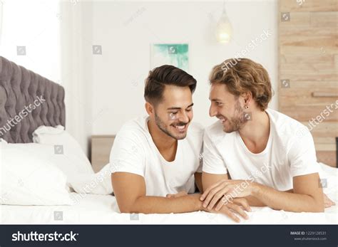 Happy Gay Couple Lying On Bed Stock Photo 1229128531 Shutterstock