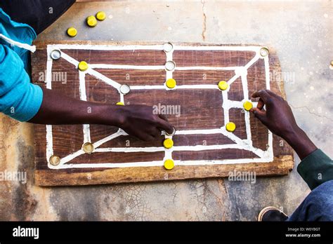 Traditonal African Strategy Board Game Know As Morabaraba Or Muravarava Being Played On A Wooden