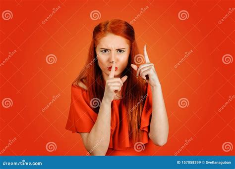 Woman Showing Hush With One Hand And Attention Listen To Me With Other