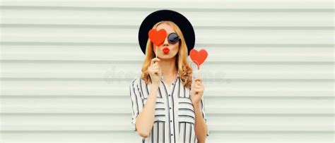 Portrait Of Beautiful Young Woman With Red Heart Shaped Lollipop