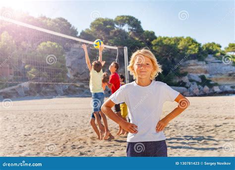 Smiling Boy Playing Beach Volleyball With Friends Stock Image Image