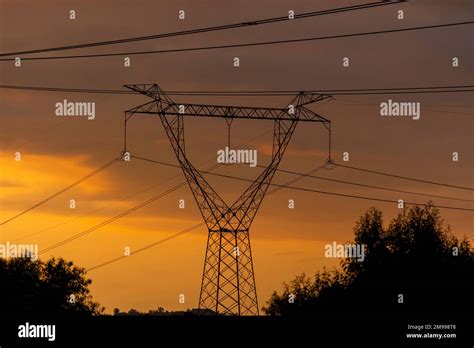 High Voltage Electrical Towers With The Sunset In The Background Stock