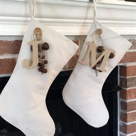 Two Christmas Stockings Hanging From A Fireplace With The Letters J And