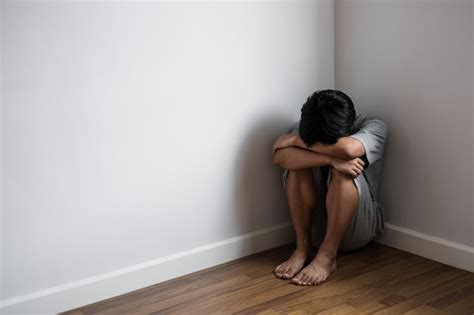 Premium Photo Depressed Young Man Sitting Alone In Corner Of Room