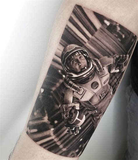 A Man S Arm With An Astronaut Tattoo On It In Black And White