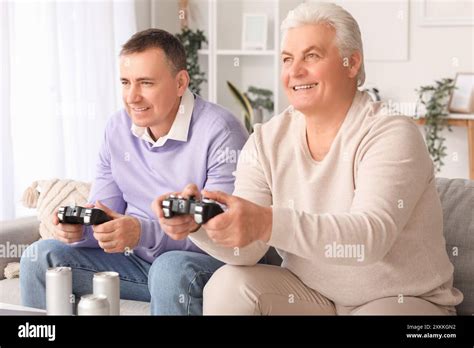 Mature Brothers Playing Video Game At Home Stock Photo Alamy