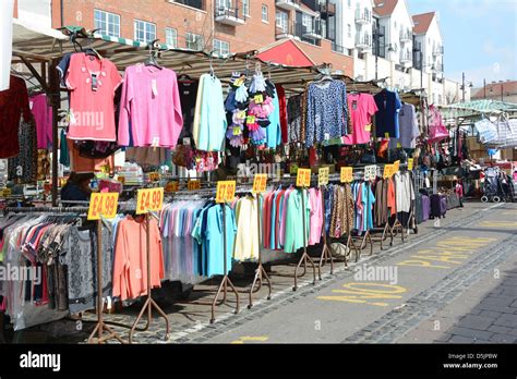 Romford Market Stall With Bargain Clothing On Hanging Rails With Price