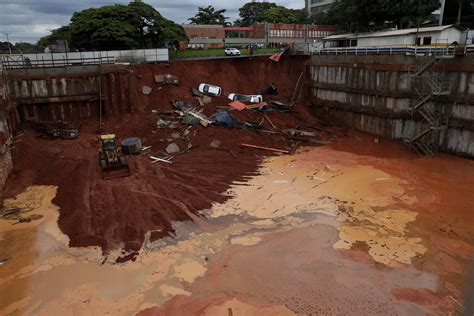 Landslide in Brazil capital spills 4 cars into building site