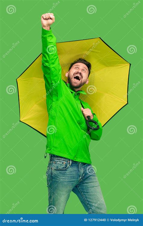 Handsome Bearded Young Man Holding Umbrella And Looking At Camera