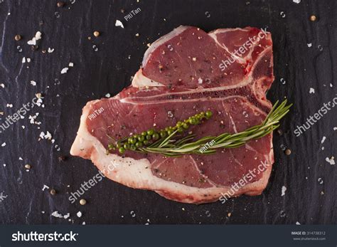 T-Bone Cut, Red Raw Fresh T-Bone Steak Cut Put With Rosemary Herbs Seasoning On Black Background ...