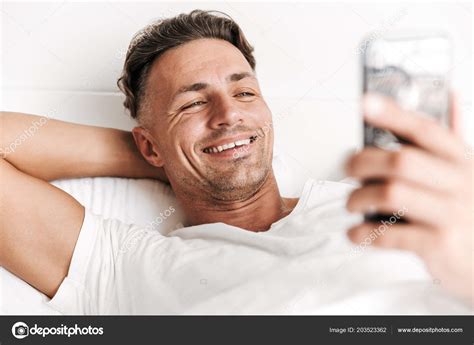 Close Smiling Man Using Mobile Phone While Laying Bed Stock Photo By