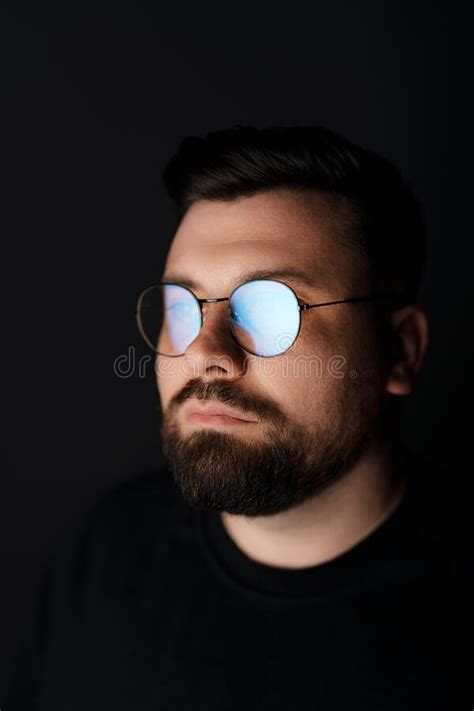 Thoughtful Bearded Man In Sunglasses And Hood In Darkness Stock Image