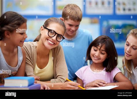 Sharing Her Love Of Education Portrait A Teacher Helping Her Students