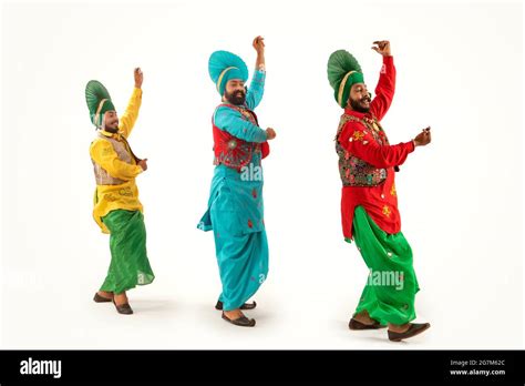 Three Bhangra dancers performing a dance step with hand gestures Stock ...