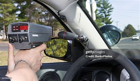 Police Officer Using A Handheld Radar Gun High-Res Stock Photo - Getty ...