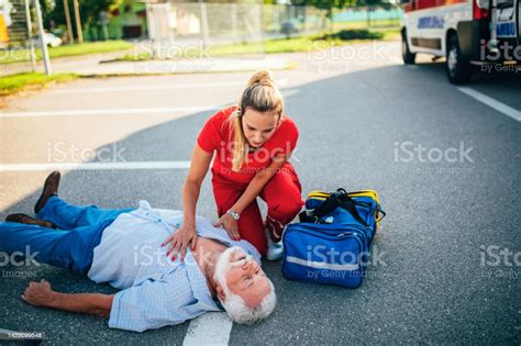 Team Paramedic First Aid On Road Ambulance Stock Photo Download Image