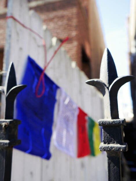 Premium Photo Fence Against Prayer Flags And Building