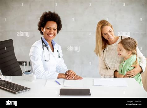 Cute little girl with her mother at the pediatrician examination by ...