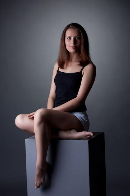 Premium Photo Lovely Slim Woman Posing Sitting On Cube