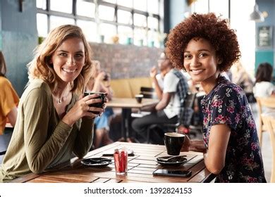 Portrait Two Female Friends Meeting Sitting Stock Photo 1392824153