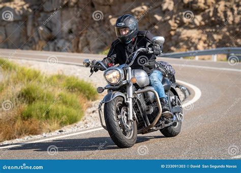 Motorcyclist Driving On The Road While Taking A Sharp Curve With His