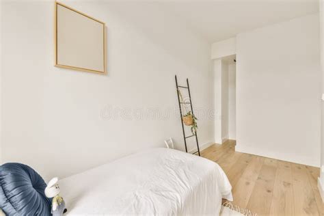 A Bedroom with a White Bed and a White Wall Stock Image - Image of ...