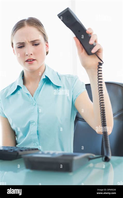 Classy angry businesswoman hanging up phone Stock Photo - Alamy